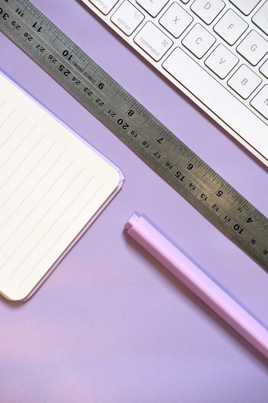 Home notebook-ruler-pen-and-keyboard-on-purple-background-8l6874-5cxc
